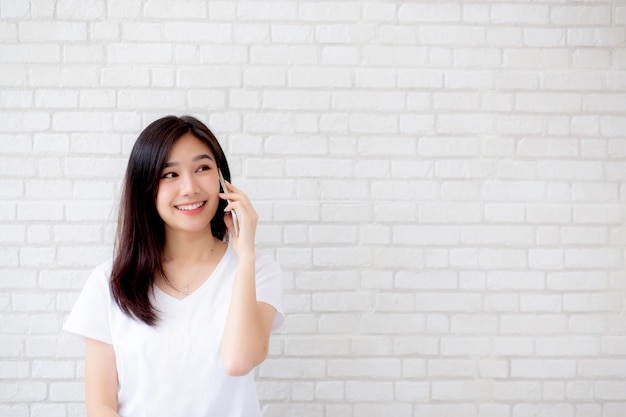 Beautiful portrait asian woman talk smart phone and smile