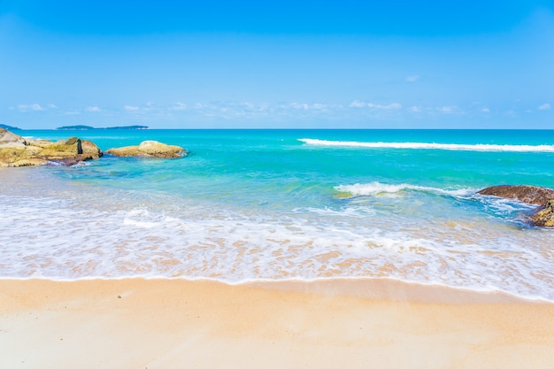 Beautiful tropical beach sea ocean with white cloud and blue sky background for travel vacation trip