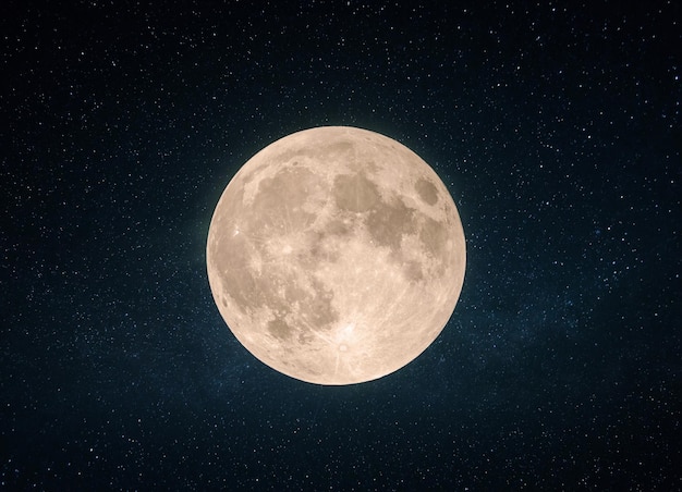 Photo beautiful yellow full moon with craters in the starry sky.