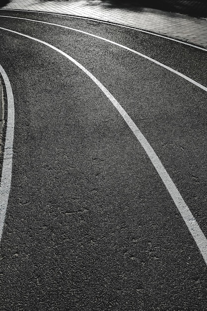 Bicycle treadmill with white dividing strips asphalt texture The concept of the competition