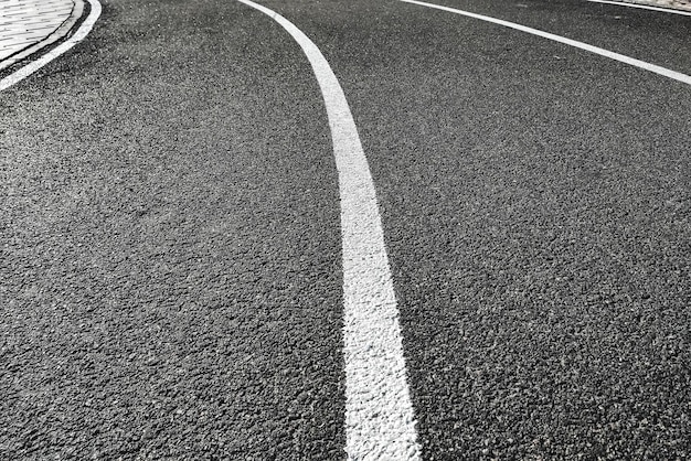 Bicycle treadmill with white dividing strips asphalt texture The concept of the competition