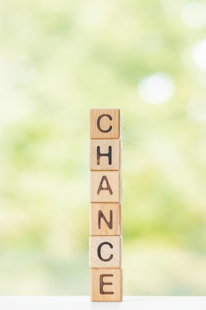 Photo big chance is written on wooden cubes on a green summer background closeup of wooden elements