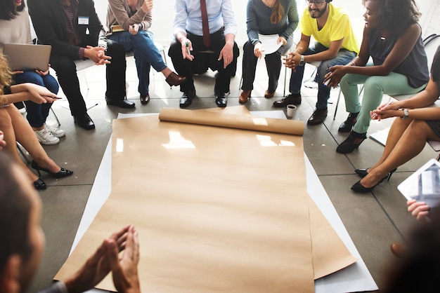 A big sheet of paper surrounded by people