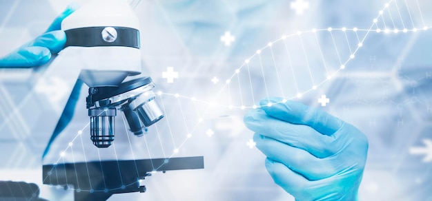 Photo biochemical research scientist working with a microscope for the virusdoctor touch arrow of the experimental results in a notebook laboratory glassware containing chemical liquid for design