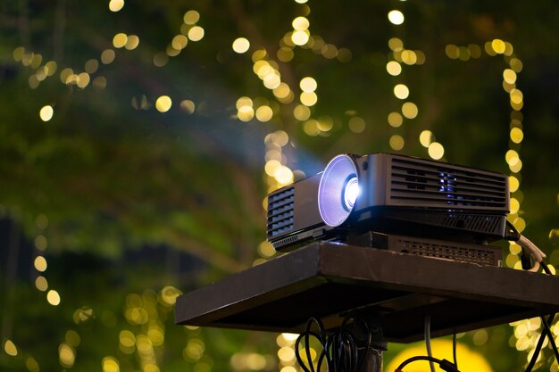 Photo black projector on stand table ready for presentation in yellow 