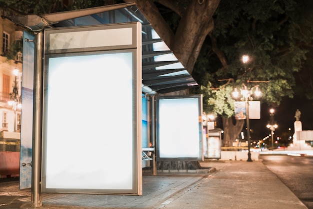 Blank advertisement billboard at bus stop near street