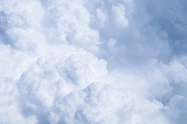 Blue sky with white clouds in sunny weather. Fluffy sky cloudy view atmosphere  from airplane window.