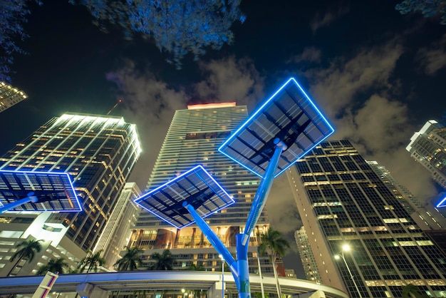 Blue solar photovoltaic panels mounted in modern city on street poles for electricity supply of streetlights and surveillance cameras Futuristic energy source in downtown Miami Florida