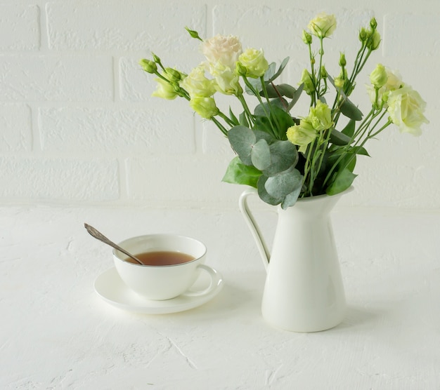 Bouquet of beautiful eustoma flowers on table in dining room. Interior design. Coffee break.