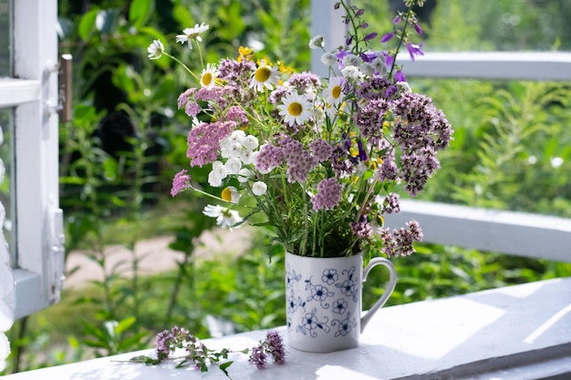 Bouquet of wild flowers on window sill