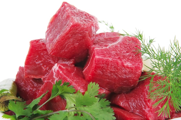 a bowl of cut up red raspberries with parsley