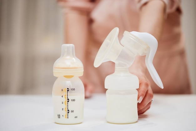 Breast pump and bottle with milk for baby