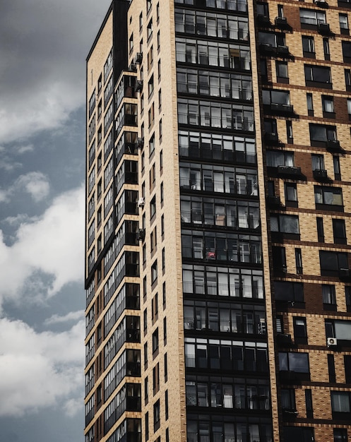 Brick of modern apartments with balconies and blue sky in the background