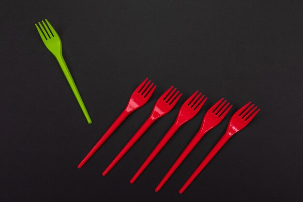 Bright green and red forks on black