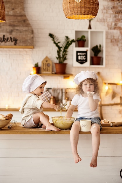 Brother and sister playing in the kitchen