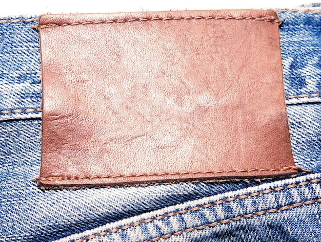 A brown leather patch on a pair of jeans