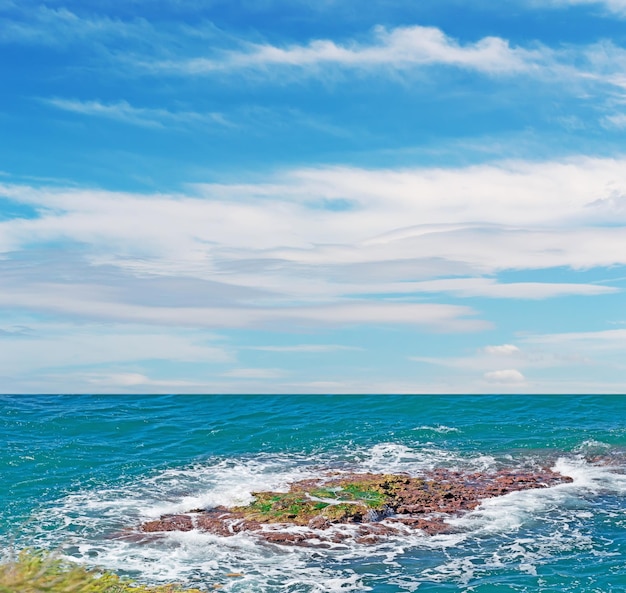 Brown rocks surrounded by waves