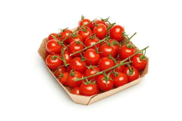 Bunches of fresh red cherry tomatoes in paper box isolated on white background Ripe tomatoes on green stems Fresh organic vitamin vegetables