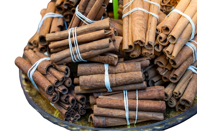 Bundle of cinnamon stick in basket isolated on white healthy spice Cinnamomum