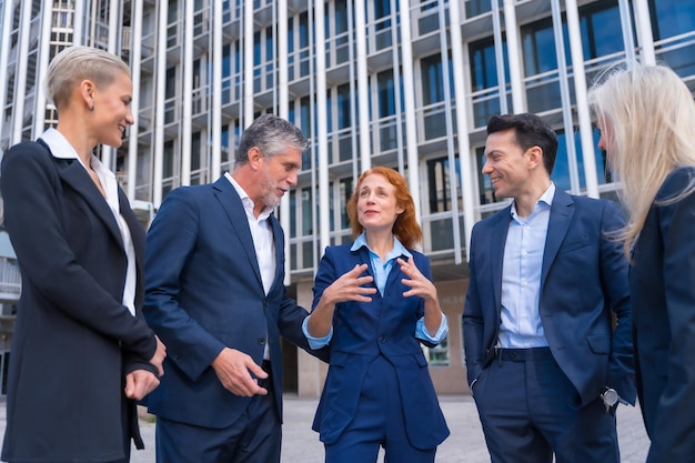 Business Executives Engaged in Conversation and Laughter in Corporate Setting