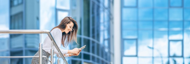 Business woman using tablet near modern business center