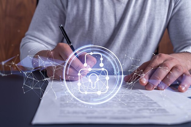 A businessman in casual wear signing the contract to prevent probability of risks in cyber security Padlock Hologram icons over the working desk