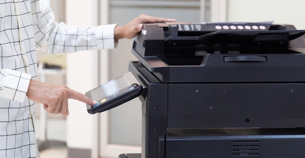 Businessman press button on panel of printer photocopier network Working on photocopies in the office concept printer is office worker tool equipment for scanning and copy paper