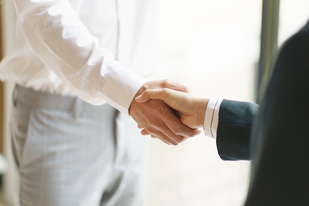 Businessman shaking hands successful making a deal mans handshake Business partnership meeting concept