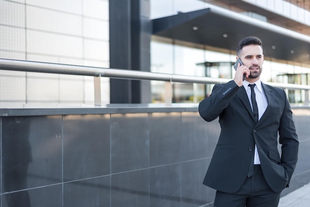 Businessman using smartphone at street