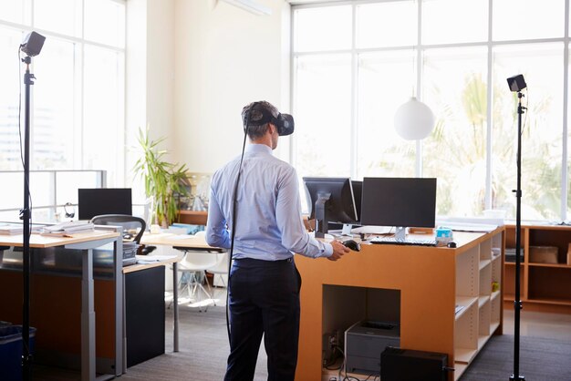 Photo businessman using vr technology in an office back view