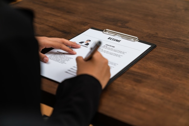 Businesswoman fill resume application information on the desk