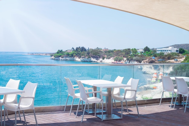 Cafe restaurant on the shores of the Mediterranean Sea Tables on the terrace in the rays of the sun