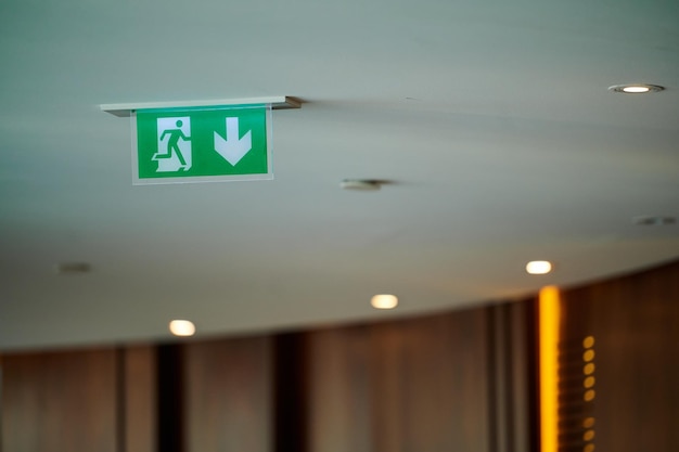 Photo ceiling sign exit entrance graphic symbol movement indicator in the interior