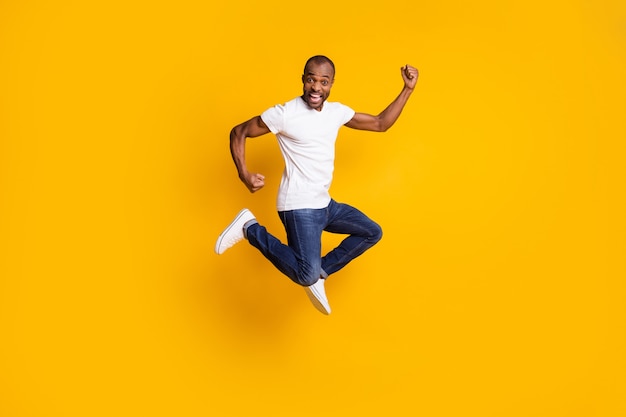 cheerful positive crazy man jump raise fists celebrate victory