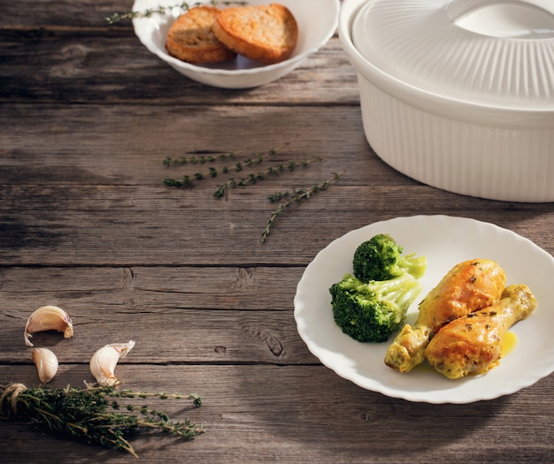 Photo chicken on plate on wooden background