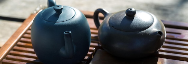 Chinese tea ceremony Ceramic teapot made of clay and bowls on a wooden background