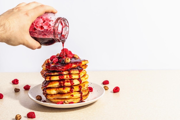 Classic homemade American pancakes with frozen raspberries hazelnut and mint Healthy breakfast