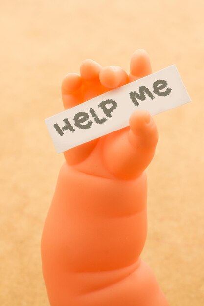 Photo close-up of artificial hand holding paper with text