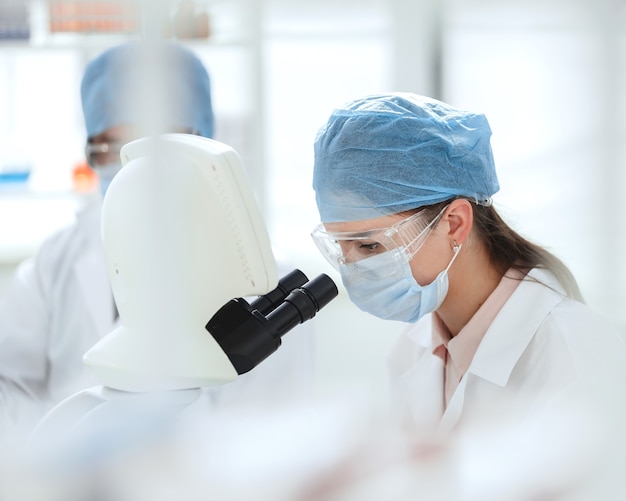 Close up. female scientist conducts research in a medical laboratory. science and health protection.