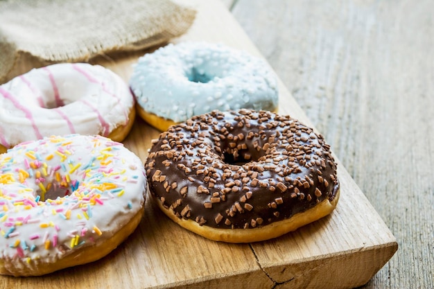 Close-up of glazed donuts on wooden background