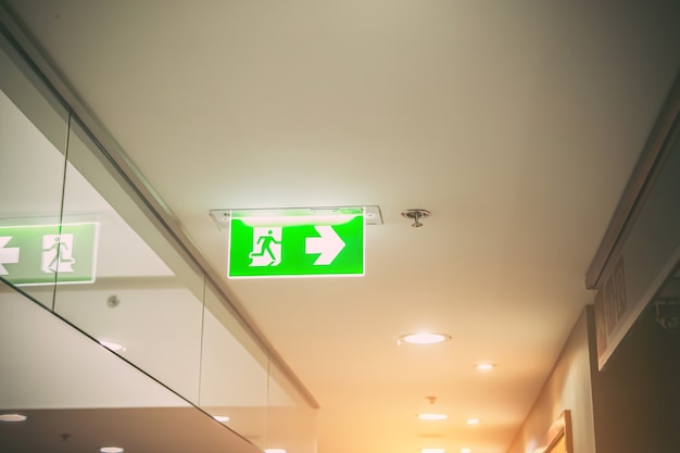 Photo close up the green fire exit sign.