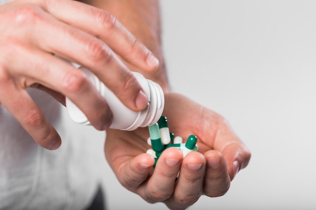 Close-up hands holding colorful capsules