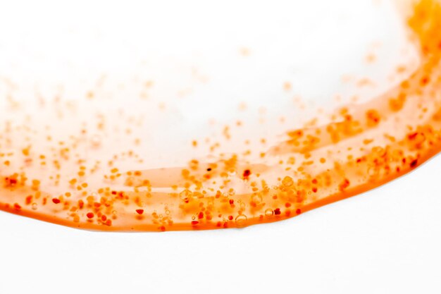 A close up of a red and orange soap on a white surface