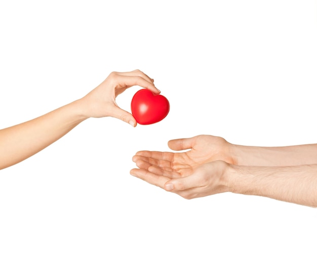 close up of woman hand giving heart to man