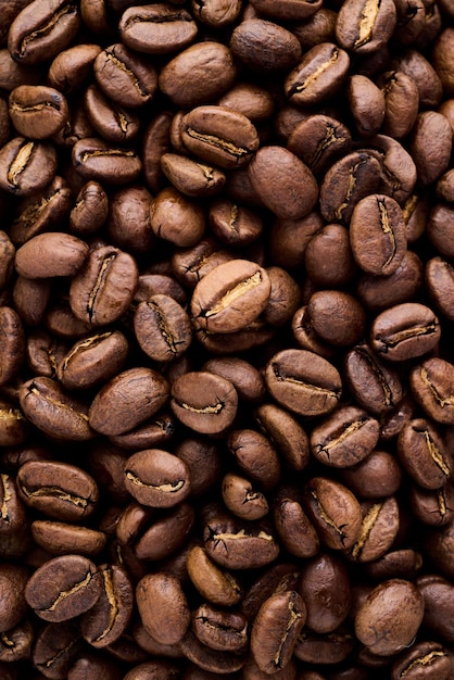 Closeup of dark coffee arabica beans texture. Caffeine aroma. Heap of scented black grains