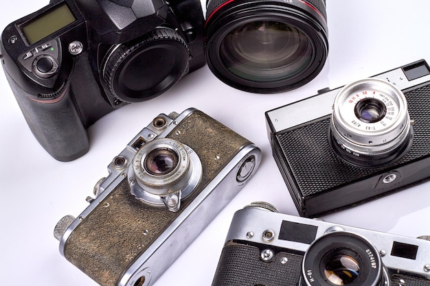 Closeup oldfashioned vintage photo cameras on white background