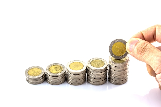 coin stack with hand hold the coin on white background