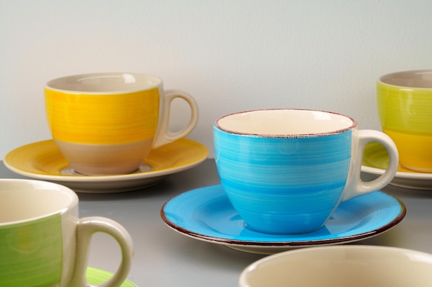 Colorful clay ceramic cups on gray background