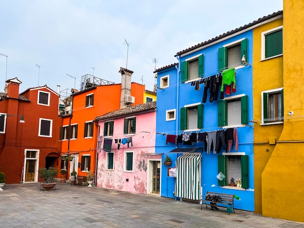 Colorful houses on a small traditional square at Burano island Venice Italy