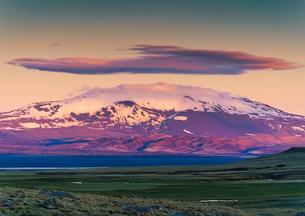 Colorful volcanic mountain with cap cloud among the Icelandic Highlands on summer at Iceland